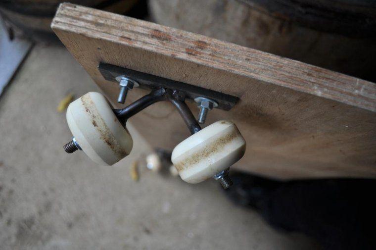 Some nuts and bolts, skateboard wheels, a piece of plywood...